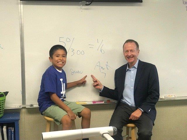 Los Angeles Schools superintendent Austin Beutner congratulates a student on his math work on the first day of school 
