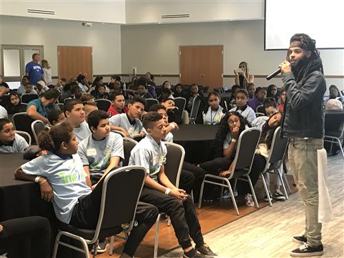 Dee-1, a middle school math teacher turned inspirational rap artist, addresses CMSD eighth-graders during True2U kickoff.  
